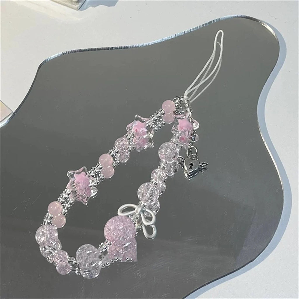 Pink beaded phone strap with star and bow charms, Y2K style