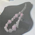 Pink beaded phone strap with star and bow charms, Y2K style