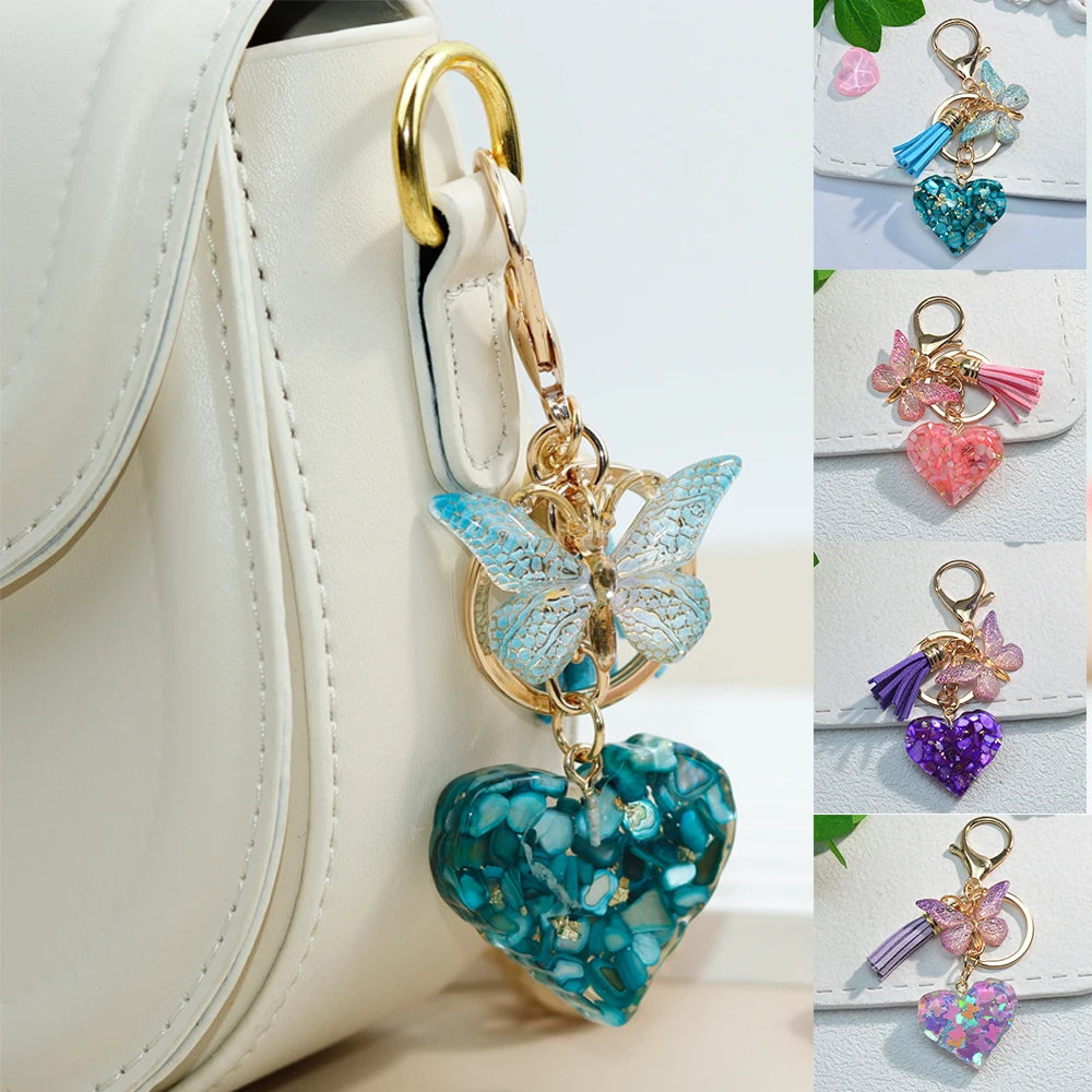 Sequin-filled heart bag charm with a rhinestone butterfly and tassel