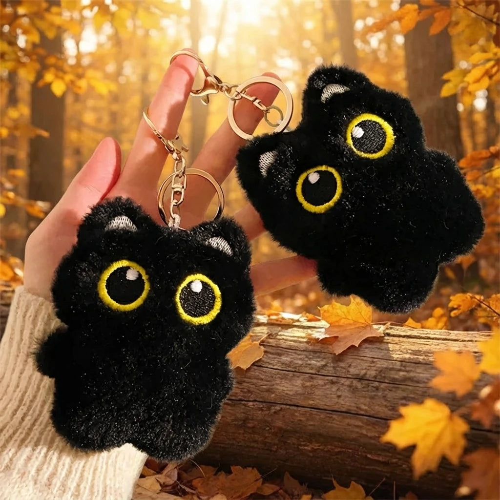 Squeezable black cat squishy plush keychain with big eyes